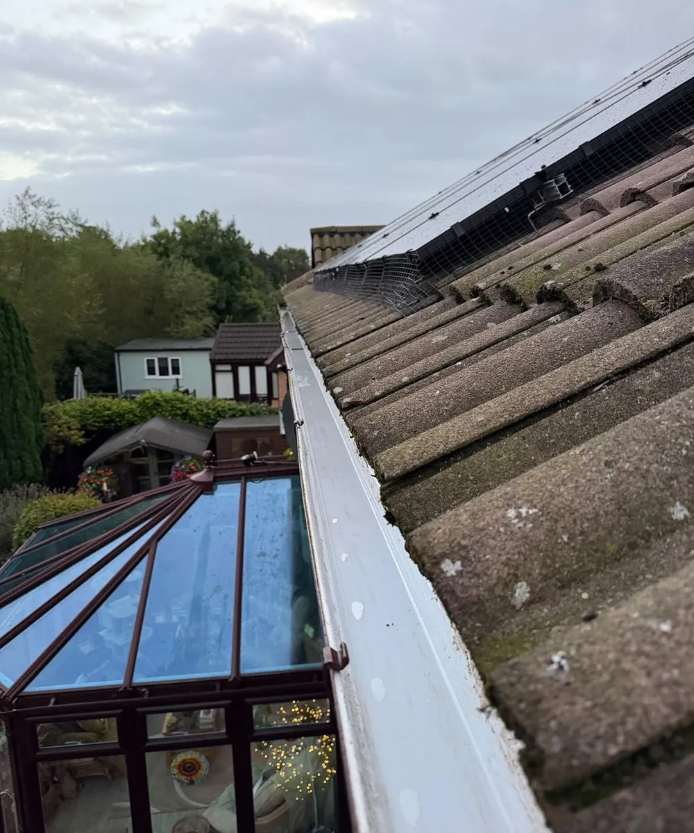The same gutter run after clearing, empty and clean